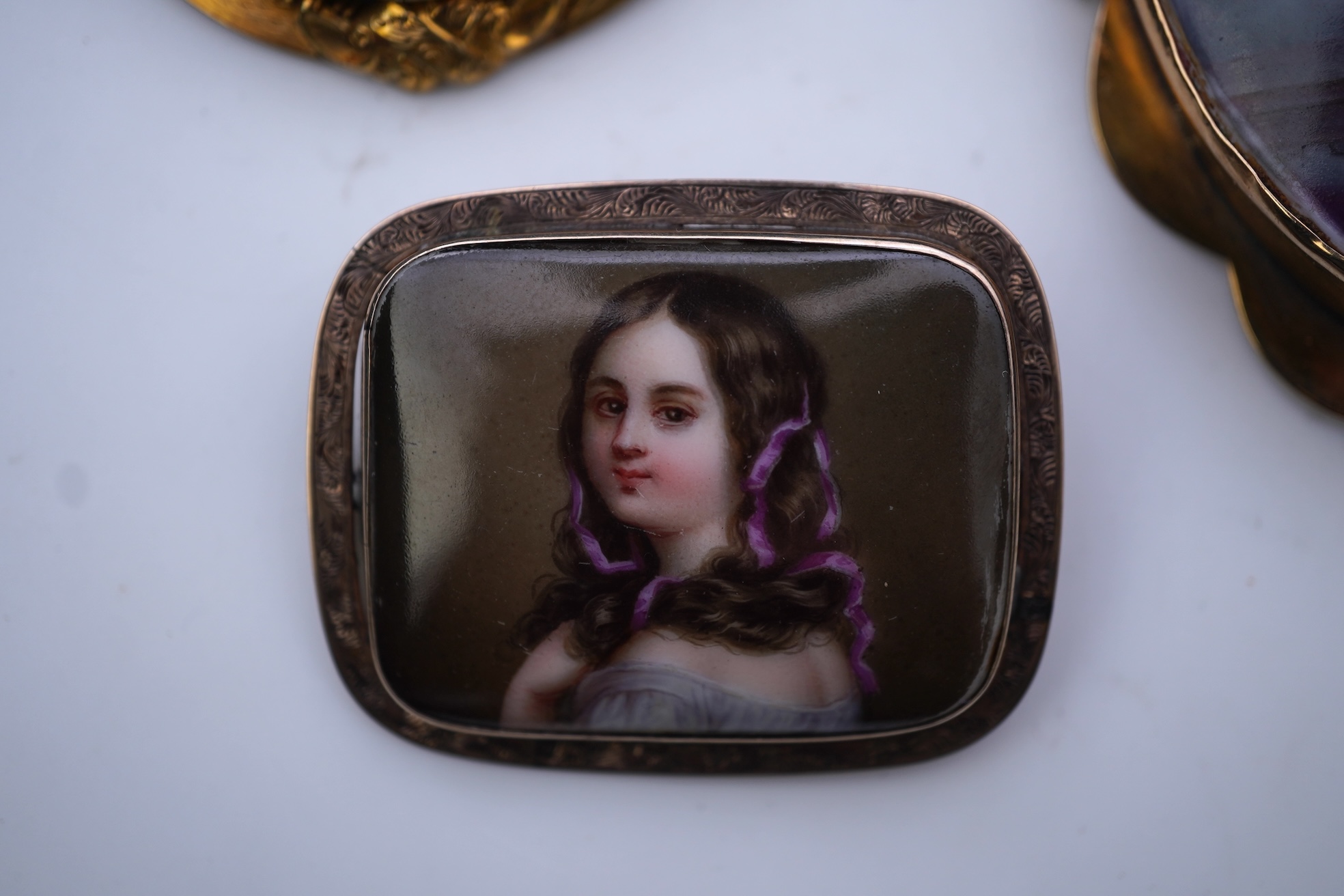 Three painted enamel brooches, mid 19th century